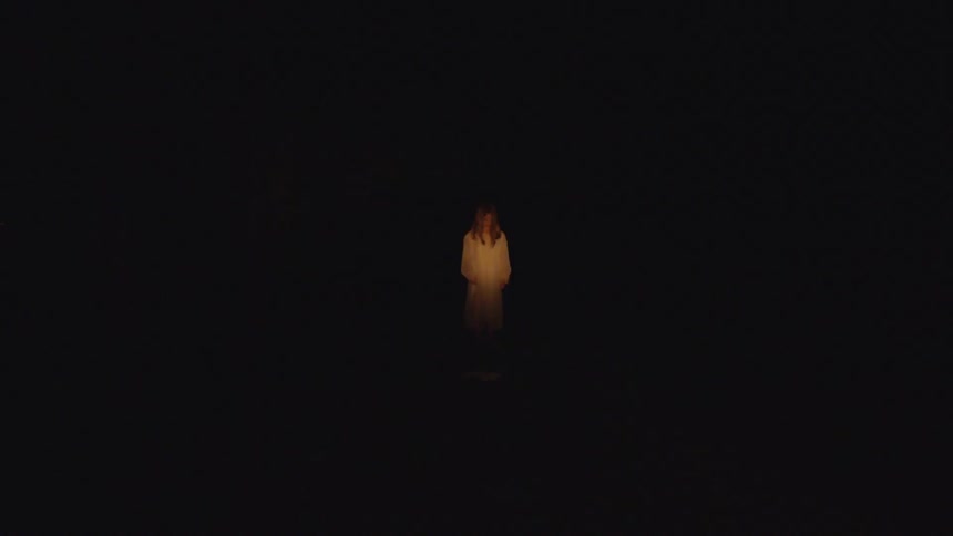 A woman standing next to a fire
