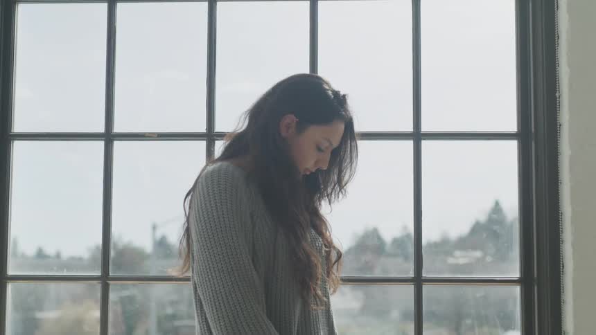A woman looks down at the floor