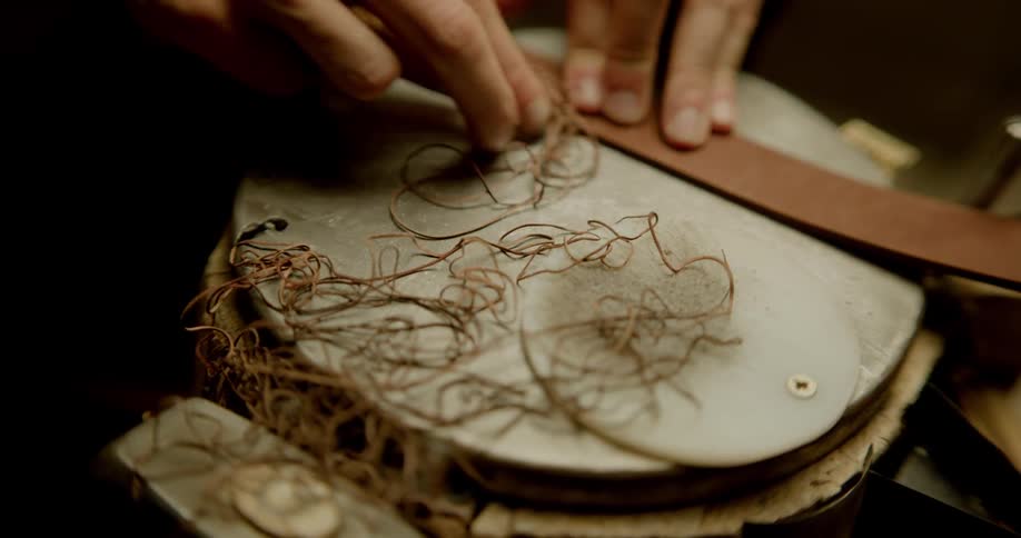 Person shaves strips off strip of leather