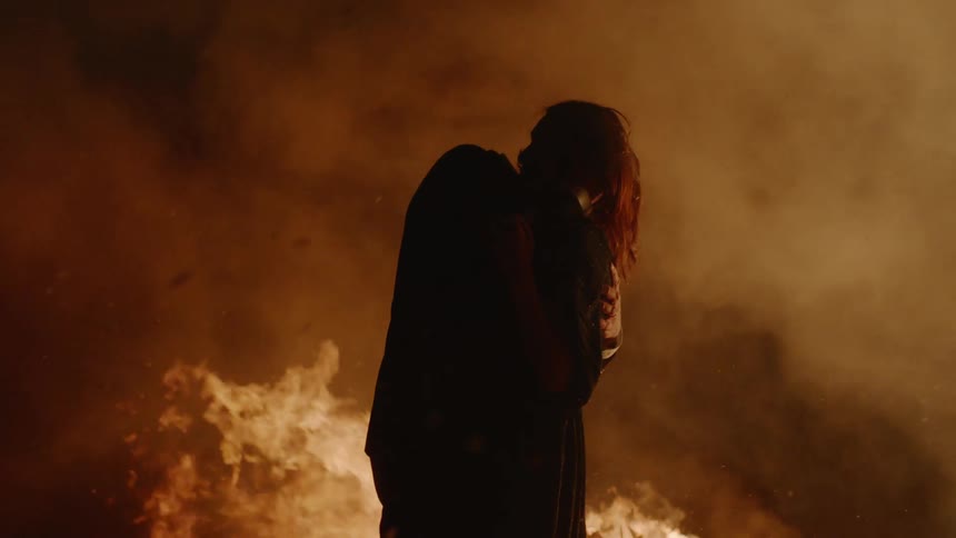 Couple Kissing By Fire In Desert