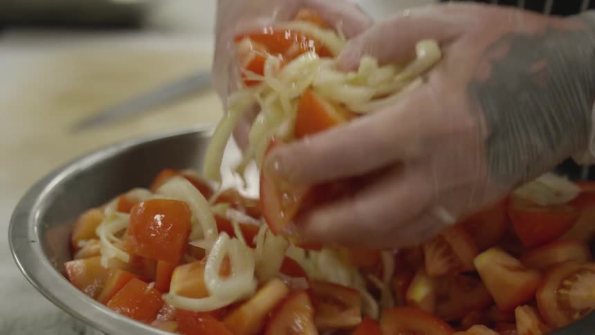 A person is mixing food in a bowl