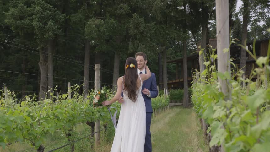 Man and woman kissing in a vineyard