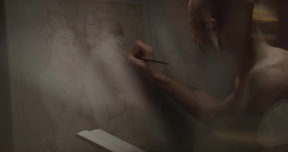 A man is drawing a picture on a canvas