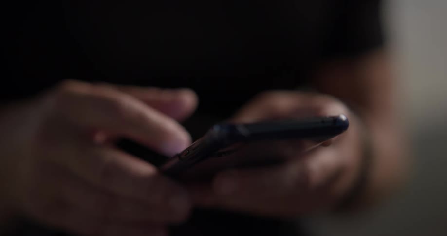 A person using a cell phone at night