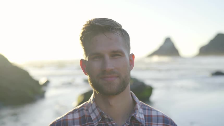 A man is smiling outside