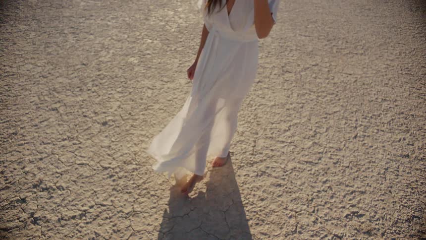 A woman is wearing a dress in a remote area