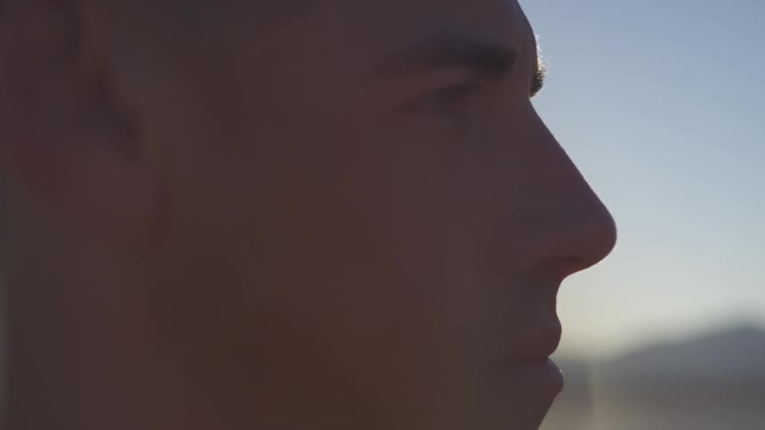 A man stares outside under the sun