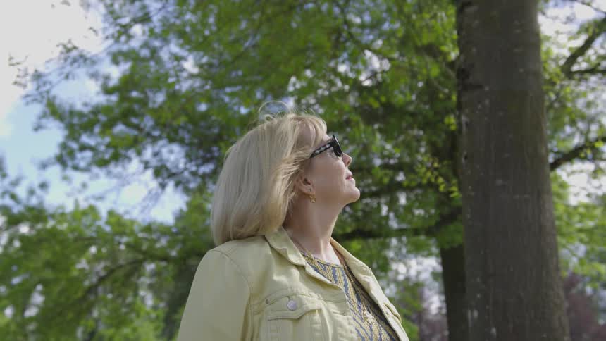 A woman walking around in a forest during the day