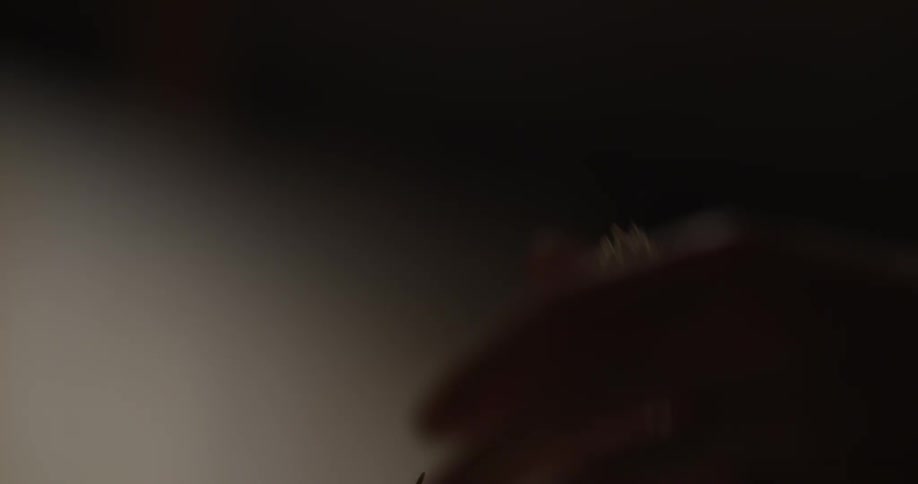 A person cleans a paintbrush