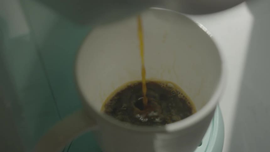 Liquid is being poured into a cup