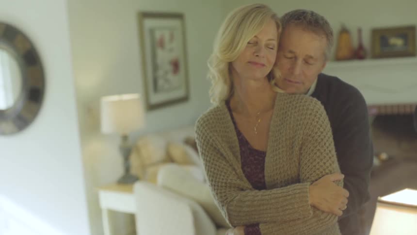 A man and woman holding each other inside