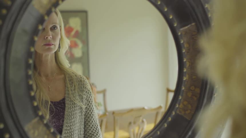 A woman looking in a mirror