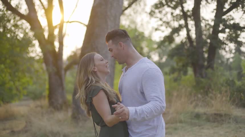 Woman and man are holding hands and standing close