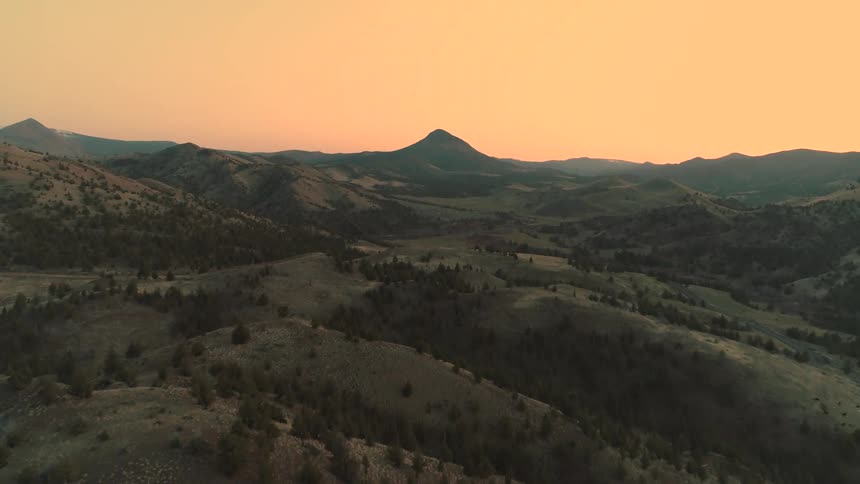 Hills roll on into the dusk