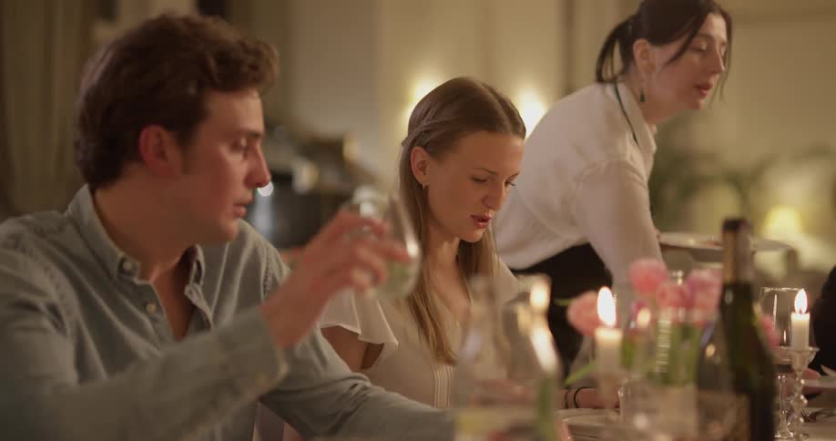 Men and women are sitting at a table drinking and talking
