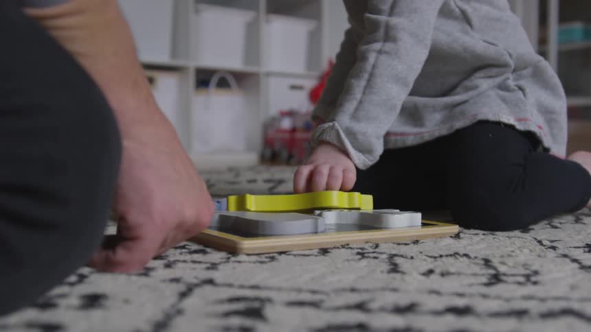 A man and child play with blocks together