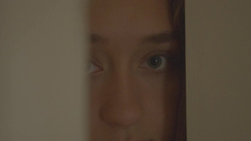 A person that is opening a cabinet and looking into it