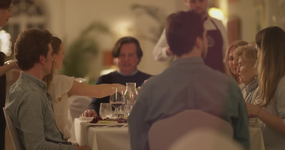 A group of people are getting their food served to them