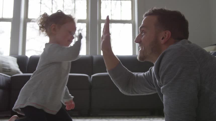 Father And Daughter Playing At Home