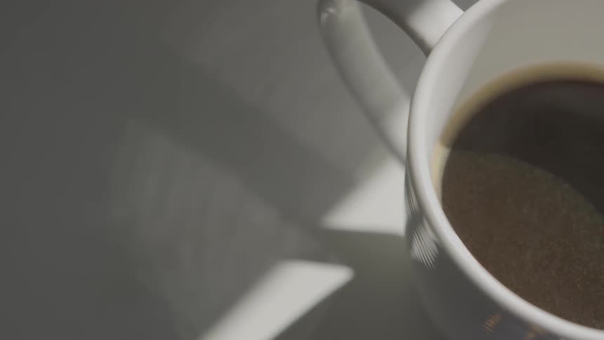 Close up of white coffee mug with coffee