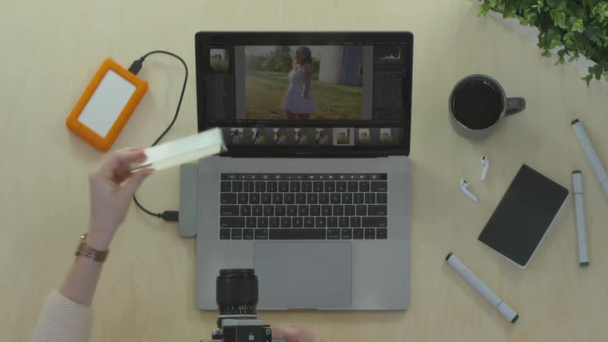 A person picks up a camera and takes a picture of something