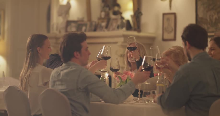 A group of people are raising their glasses