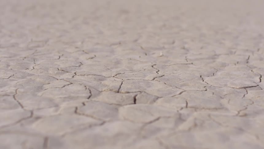 A bunch of clay on the ground that is cracked