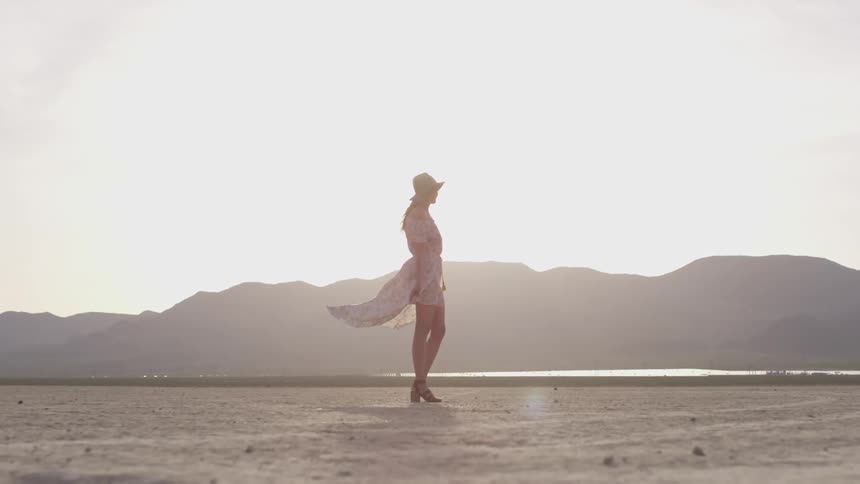 A woman standing in a dry lake bed