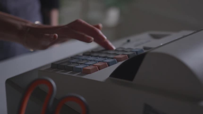 Woman uses a cash register
