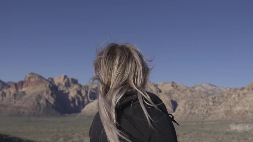 A woman's hair blowing behind her in the wind