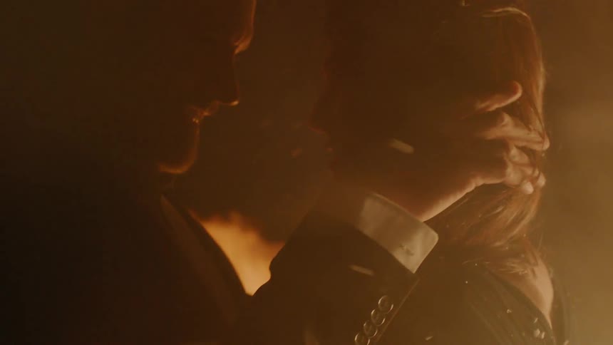 Couple Kissing By Fire In Desert