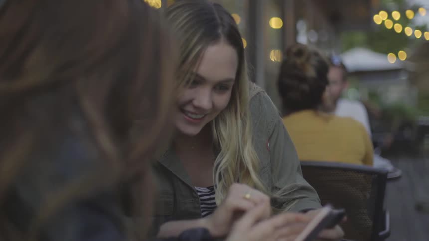 Two women looking at something on a smartphone