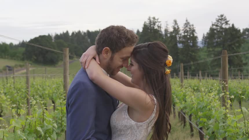 A man and woman hug in a garden