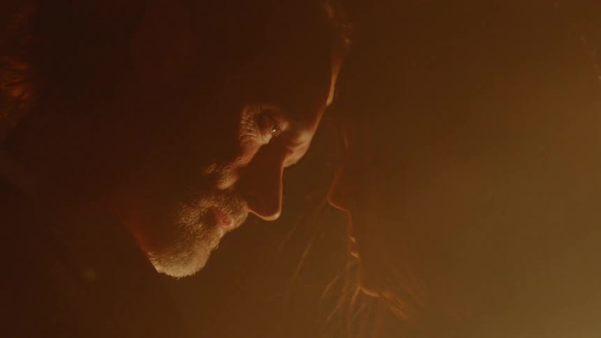 Man and woman dancing in front of a blowing fire