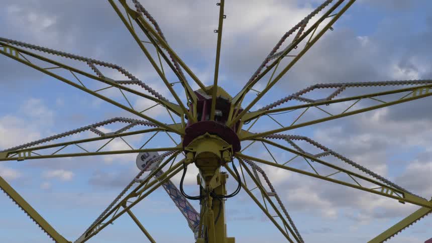 A carnival ride that is rotating outdoors
