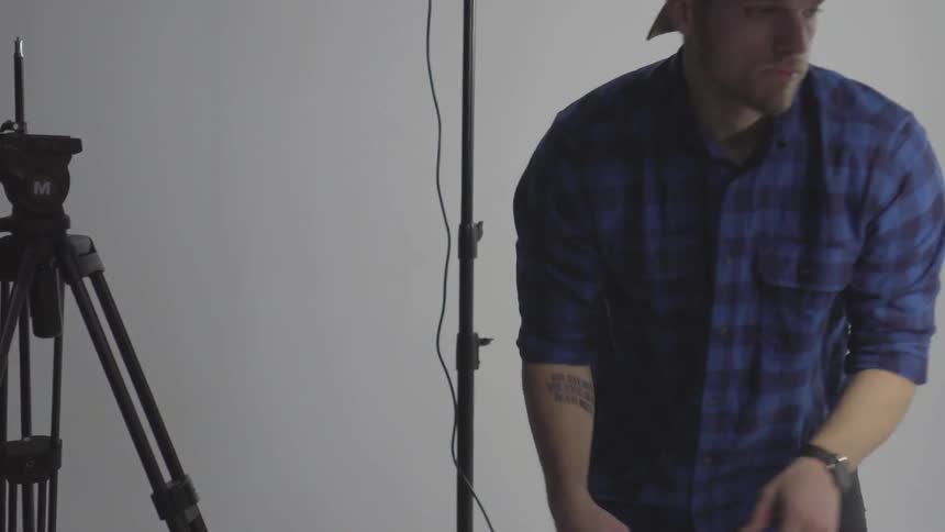 Photographer adjusts florescent lighting in his studio