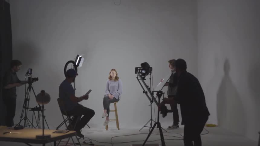 A person lowers the mechanical arm for a camera