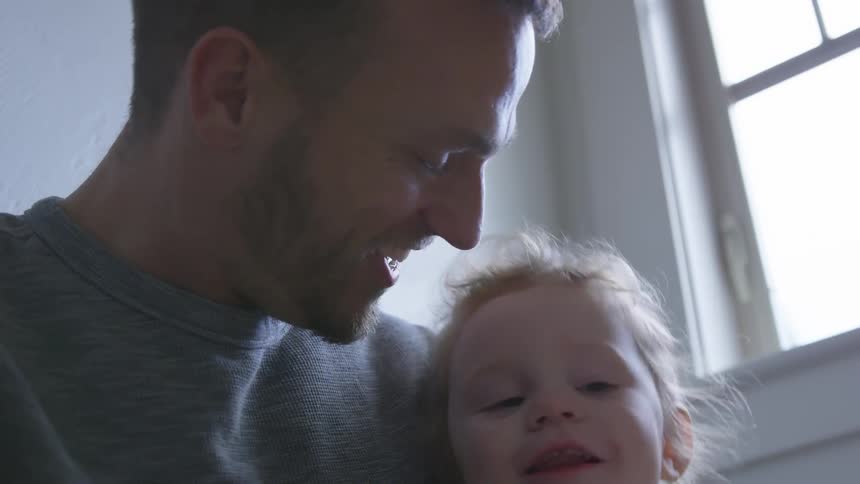 Father And Daughter Playing At Home