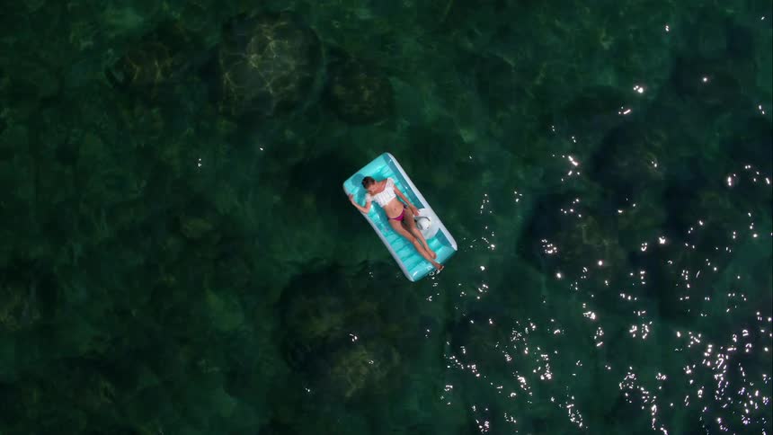 A top down view of a woman on a raft