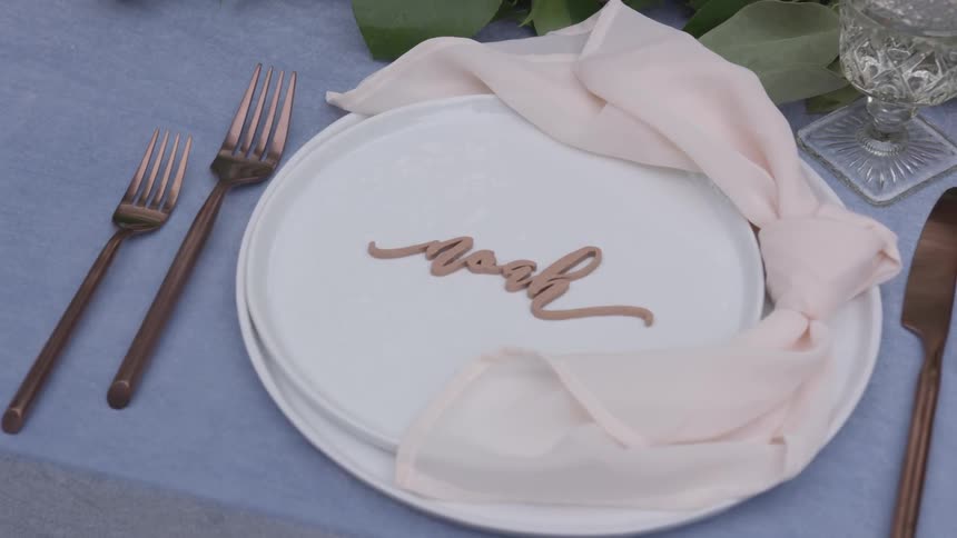 Formal place setting with script name noah on plate