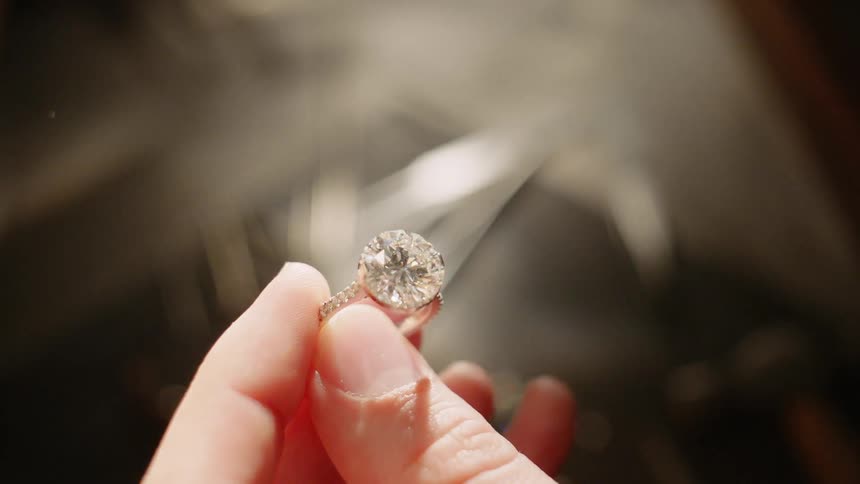 A woman holding onto a diamond ring