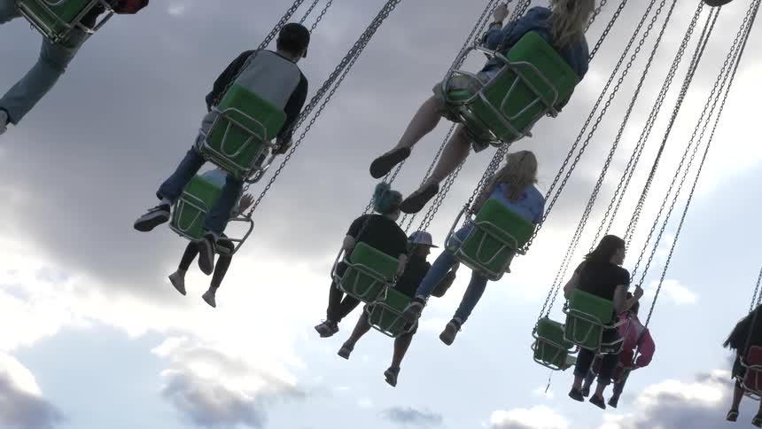 People are on a carnival swing ride