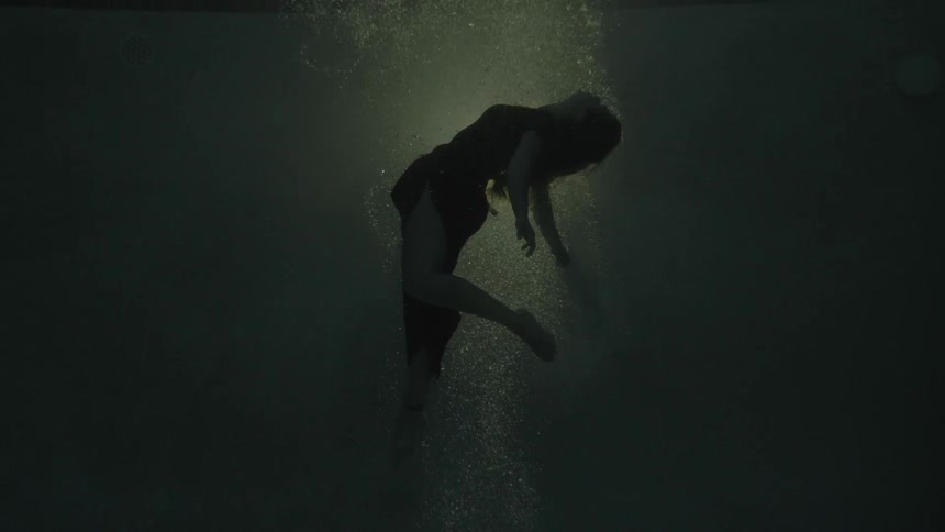 A woman floats underwater