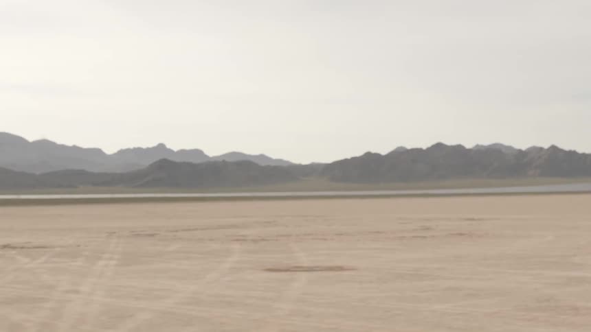 A dried lake bed near some mountains