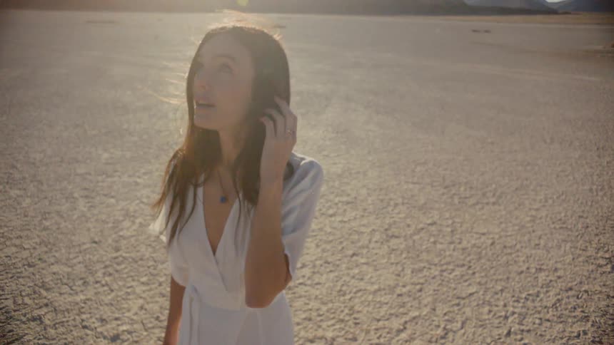 A woman walking in a white dress