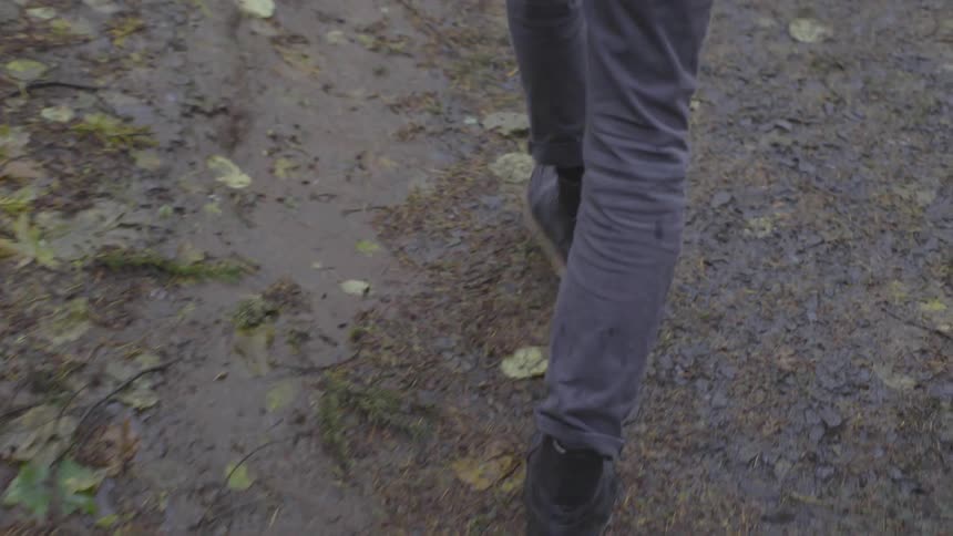 People are walking along a muddy path