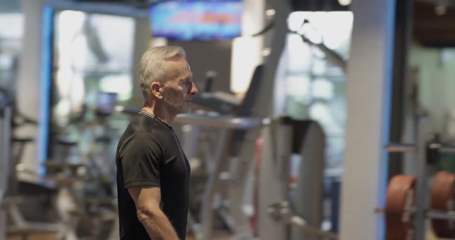 A man is in a gym walking around