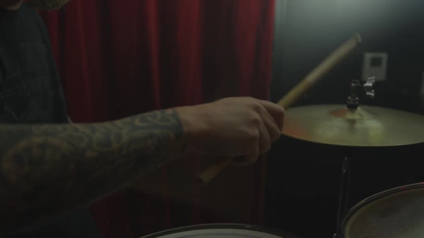 Close up of drummer playing drum kit
