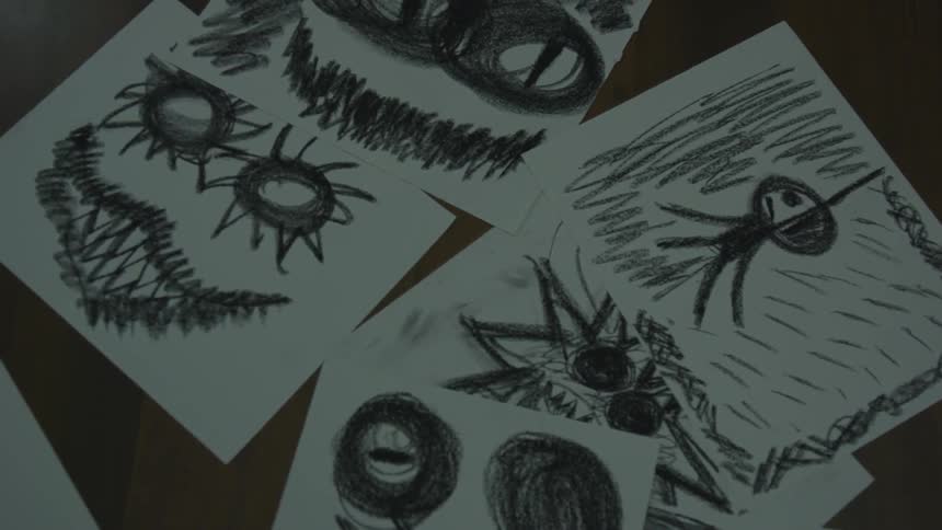 Several crude drawings in a pile