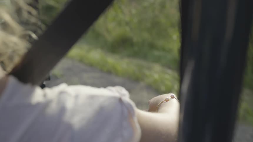 A woman with her arms out a window